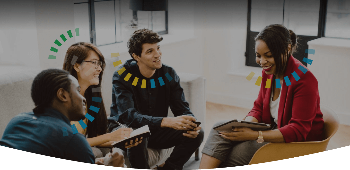 Group of smiling coworkers gathering for a meeting in a contemporary working space. All people have DiSC halos.